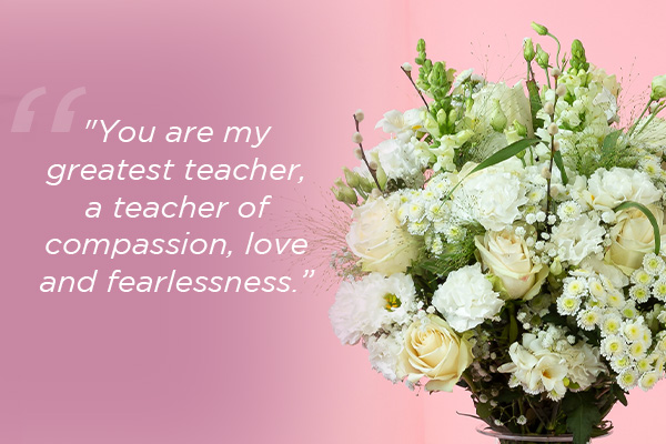 Mother's day quote overlaid on white flowers: Text reads: "You are my greatest teacher, a teacher of compassion, love and fearlessness."